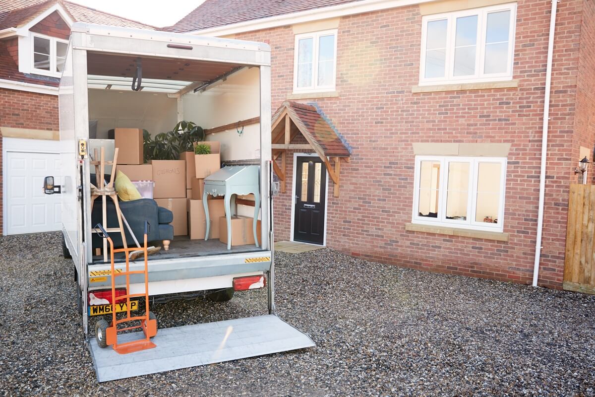 Removal truck waiting to be unloaded outside new home on moving day