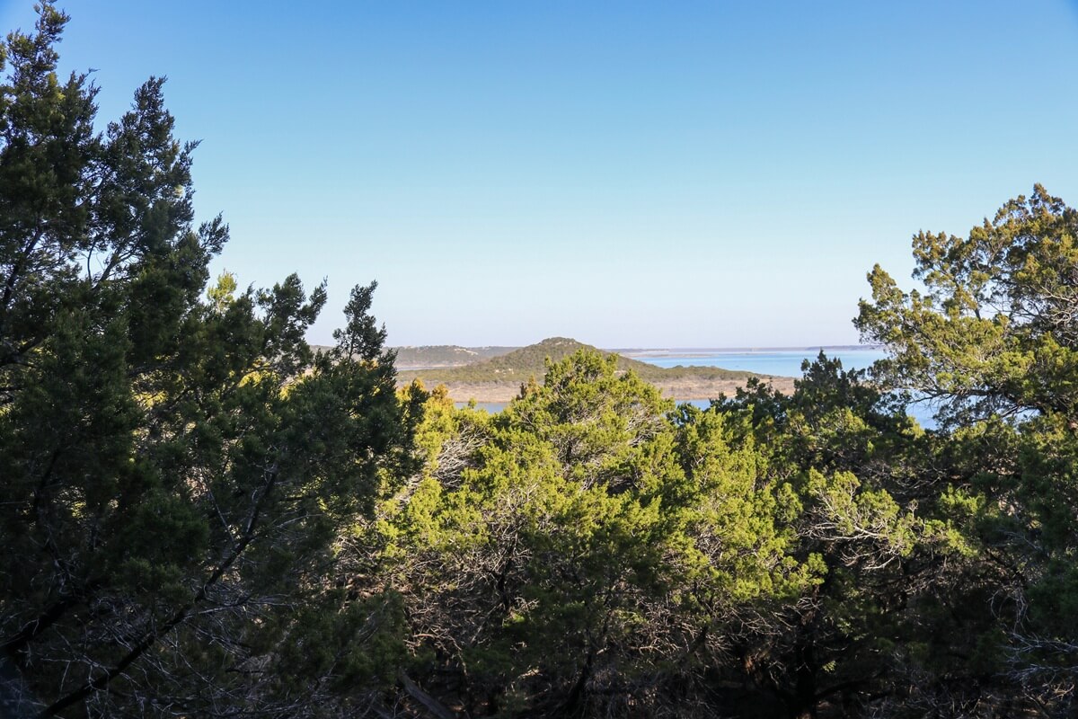 Texas Hill Country views overlooking Cedar and Oak trees with a view of Stillhouse Hollow lake in the far distance at Dana Peak public park Harker Hieghts Texas