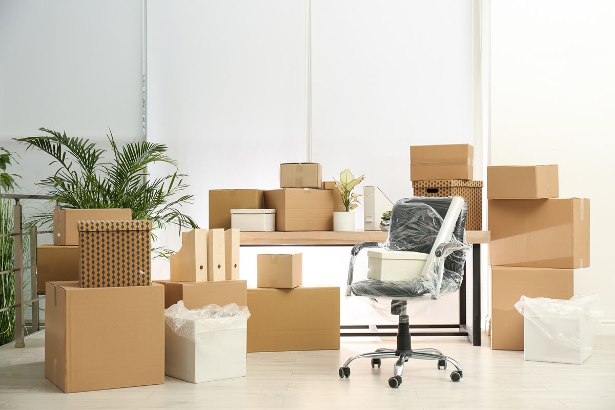 cardboard boxes and packed chair in office