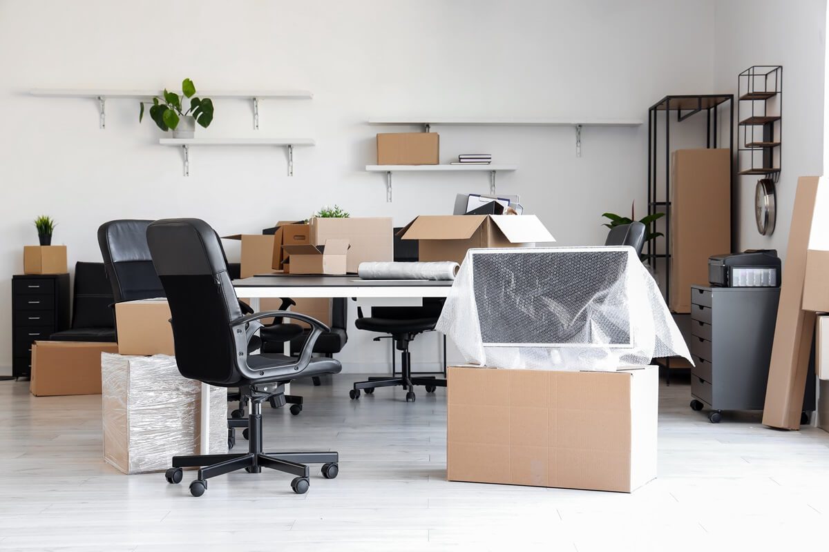 interior of light office with cardboard boxes on moving day