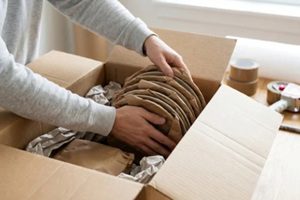 man packing dishes