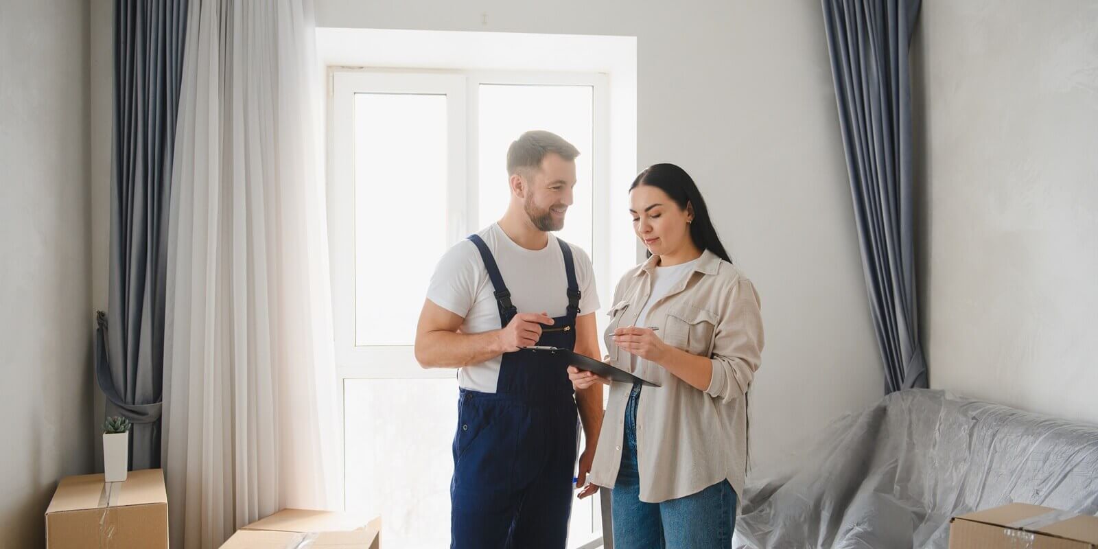 moving service professional helping woman sign relocation contract