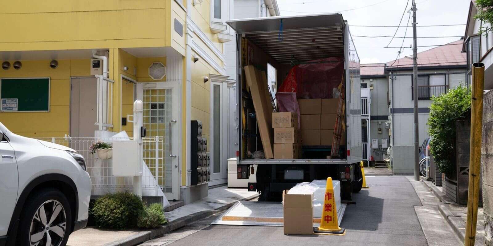 moving truck outside a yellow building